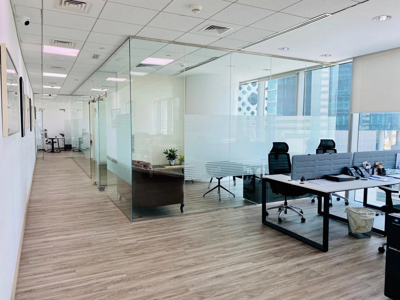 HBS Dubai open plan office with glass partitions at U-Bora Tower Business Bay — 60+ professionals